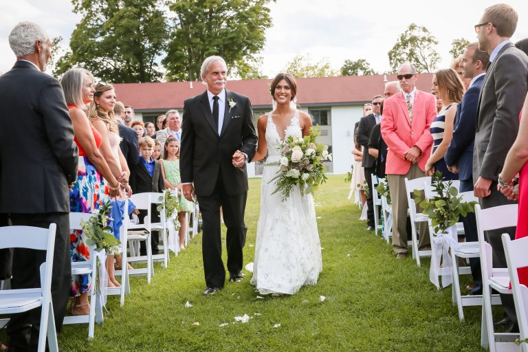 Father walking down bride down isle during ceremony