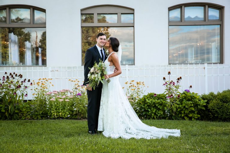 Bride and groom in front of building