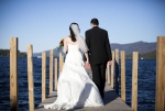 Bride and Groom posing on pier