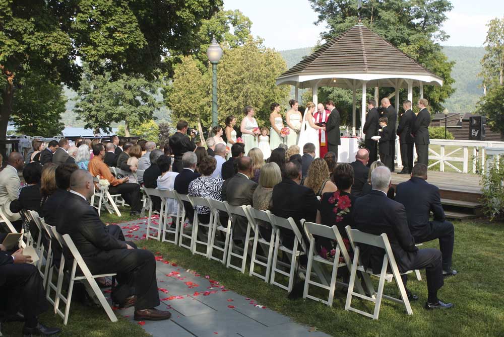 Groom saying his vows during their gazebo wedding at Fort William Henry Hotel
