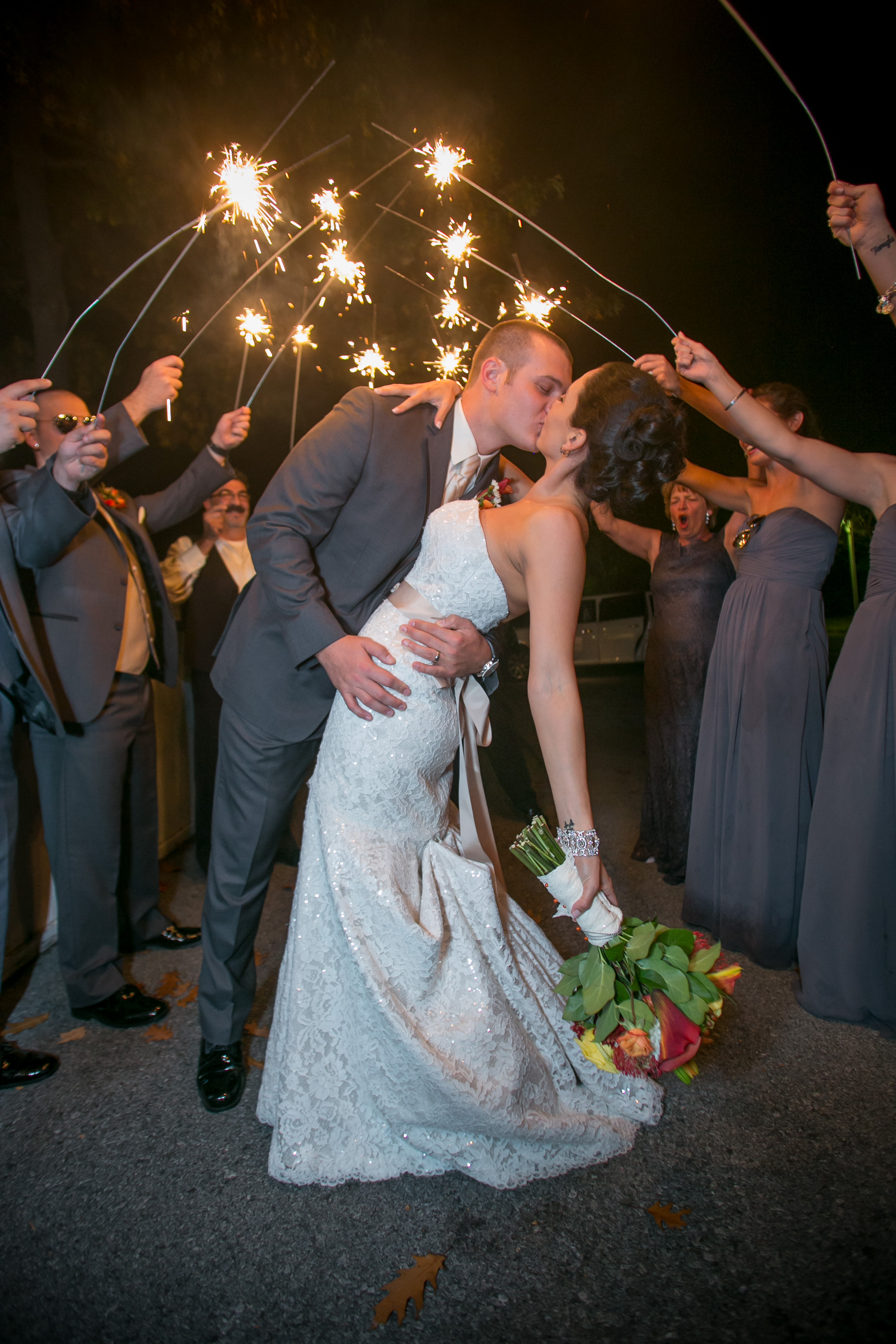 Kissing under sparklers during outdoor wedding in Lake George.