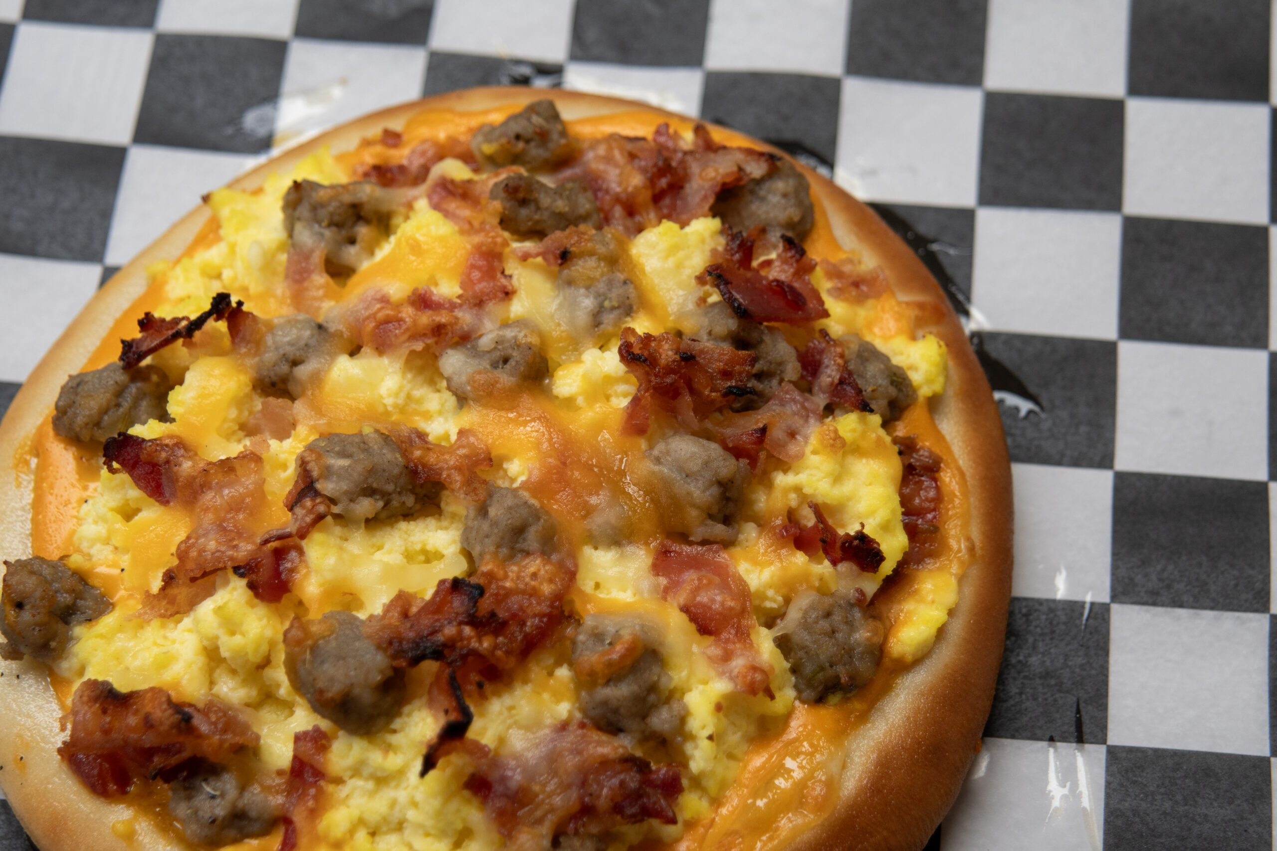 breakfast pizza with bacon eggs and sausage