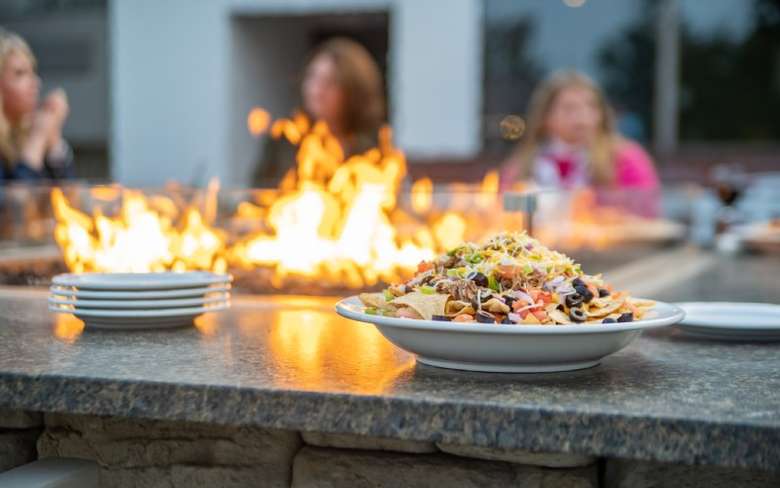 Salad on table next to firepit