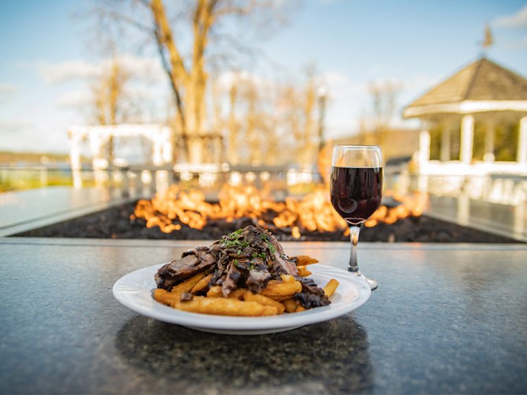 meal with wine glass next to fire table