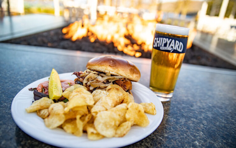 Burger and Beer in front of outdoor fire pit