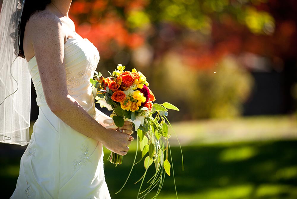 bride holding colorful flowers