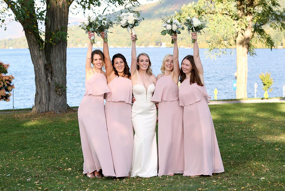 Bridesmaids holding up bouquets