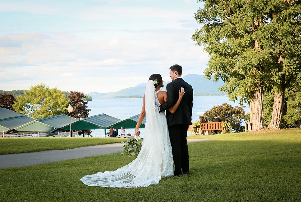 Bride and groom looking out over lake