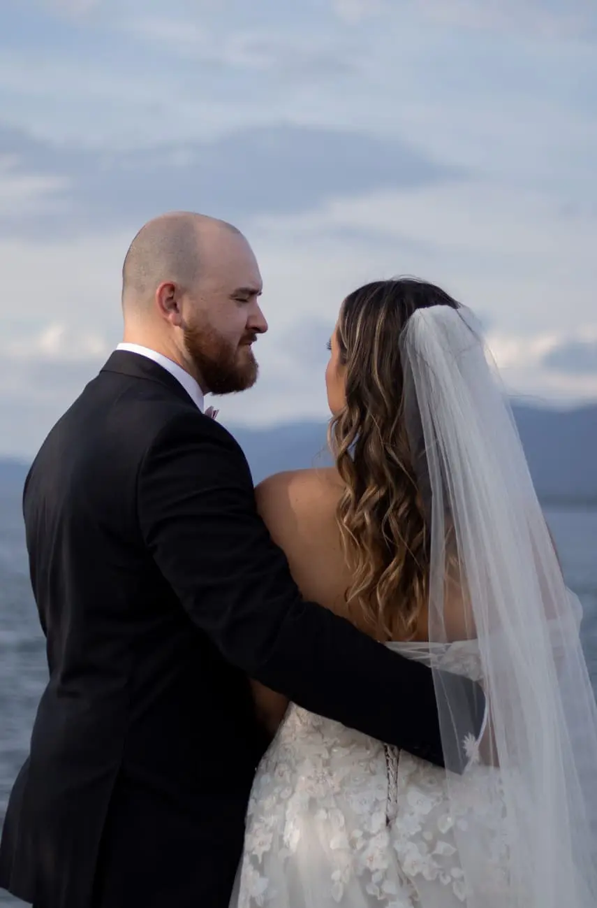 Bride and groom looking out over lake