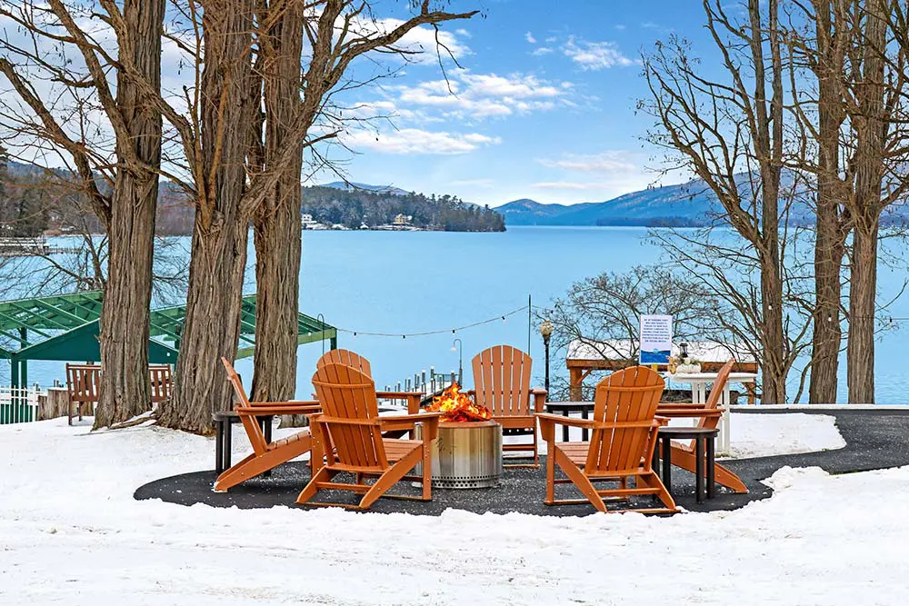 Adirondack Chairs around a fireplace overlooking Lake George
